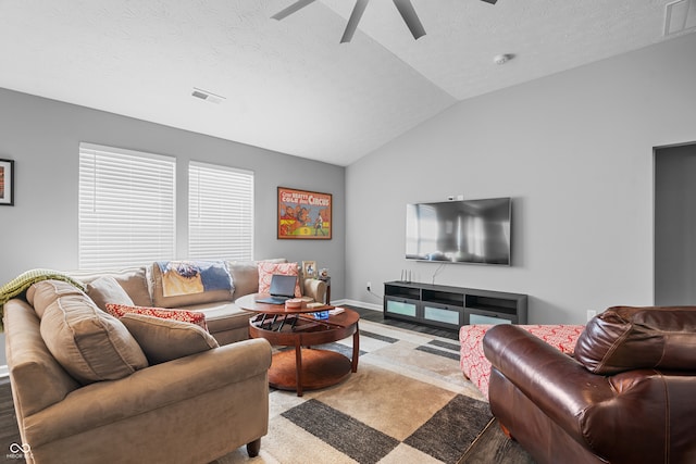 carpeted living room featuring lofted ceiling, ceiling fan, and a textured ceiling