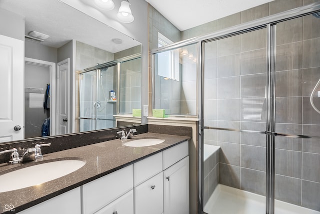 bathroom with walk in shower and vanity