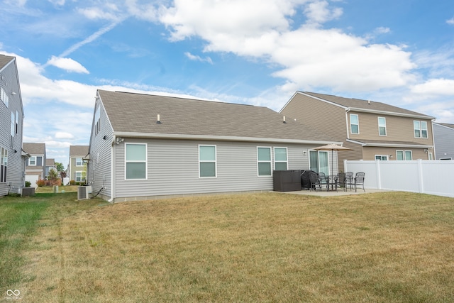 back of house featuring a lawn, a patio, and central AC