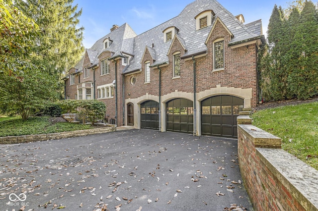 french country inspired facade with a garage