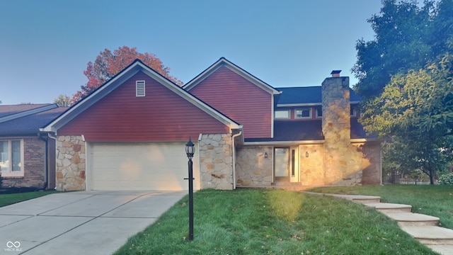 front of property featuring a front yard and a garage