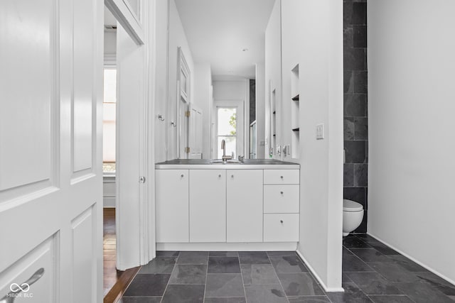 bathroom featuring toilet and vanity