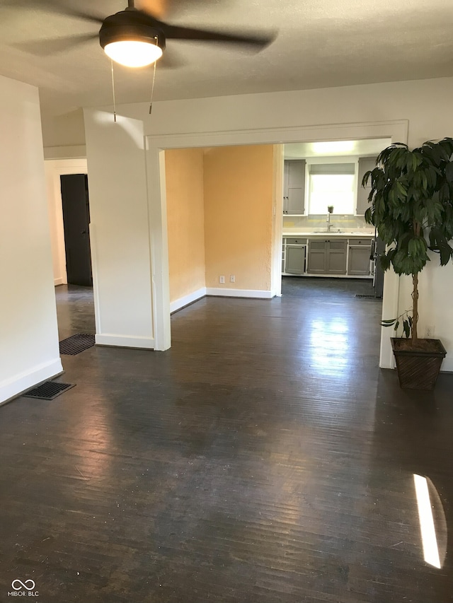 empty room with dark hardwood / wood-style floors and sink