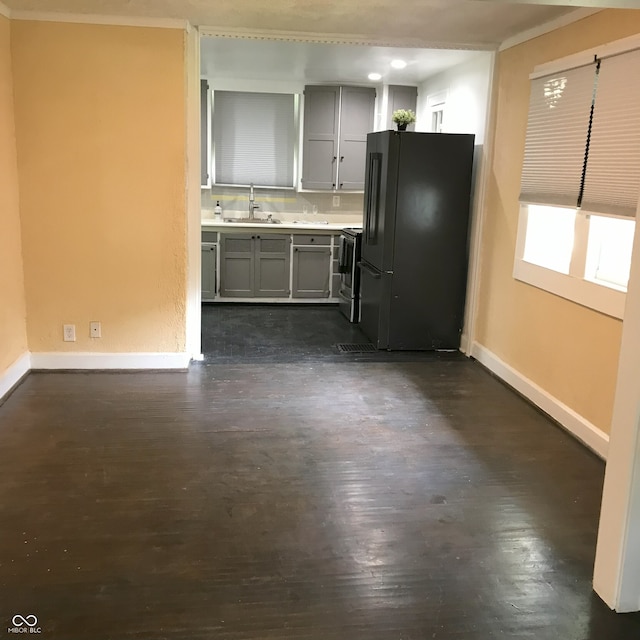 kitchen featuring black fridge, dark wood-type flooring, sink, stainless steel electric range oven, and gray cabinetry