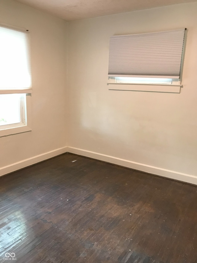 empty room with dark wood-type flooring