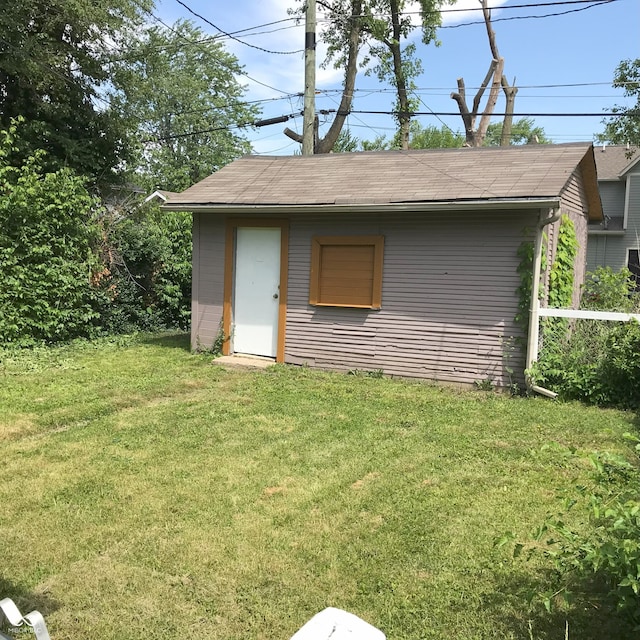 view of outbuilding featuring a yard