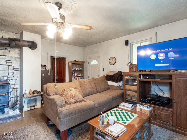 living room featuring a textured ceiling and ceiling fan