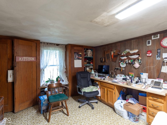 home office with wooden walls and built in desk