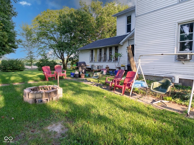 view of yard with an outdoor fire pit and a patio area