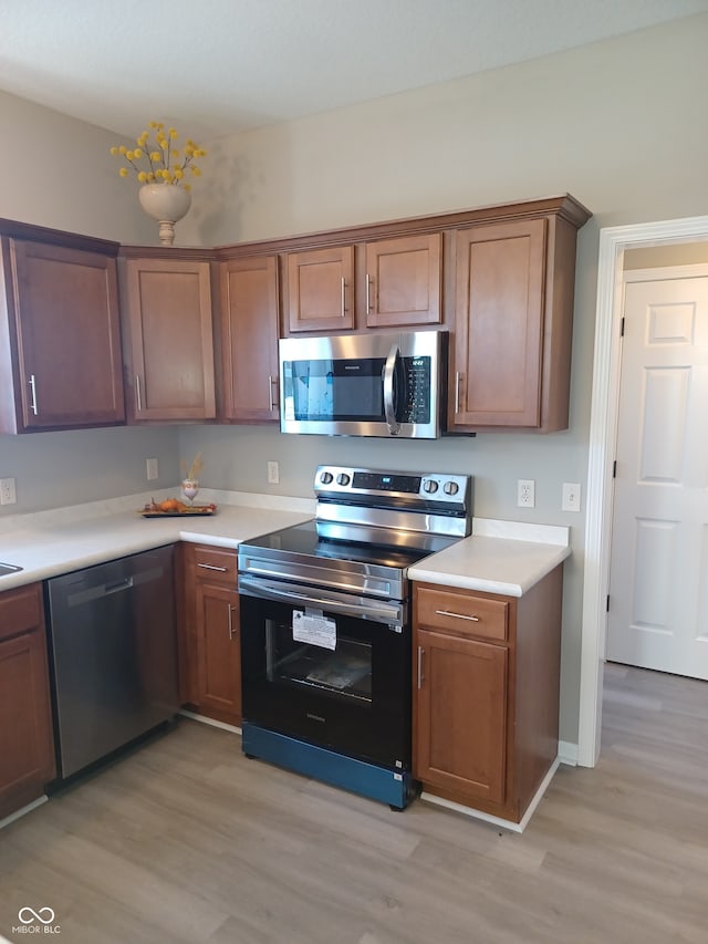 kitchen featuring light wood-type flooring and stainless steel appliances