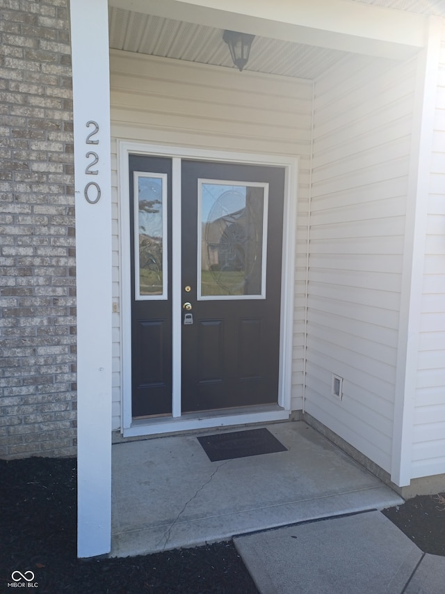 view of exterior entry with covered porch