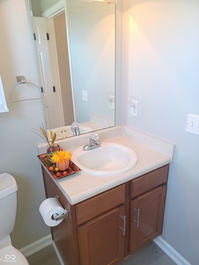 bathroom with vanity and toilet