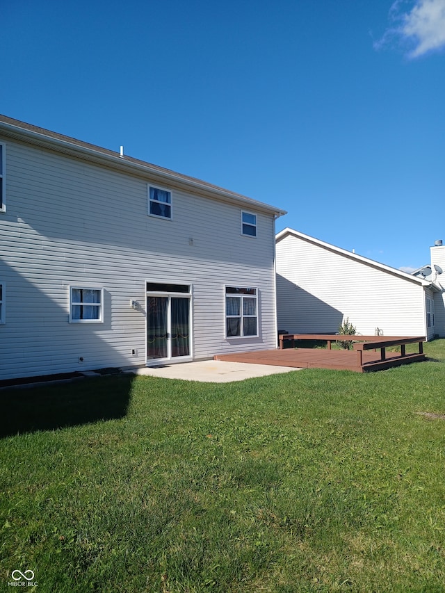 back of property featuring a lawn and a patio area