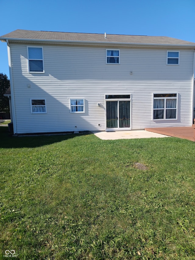 rear view of house with a patio area and a yard