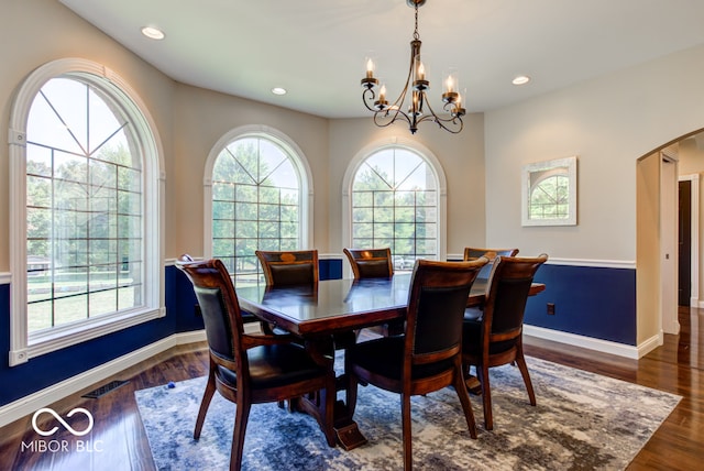 dining space with a chandelier and dark hardwood / wood-style floors