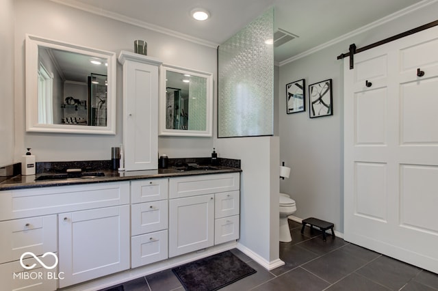 bathroom featuring toilet, ornamental molding, vanity, and tile patterned flooring