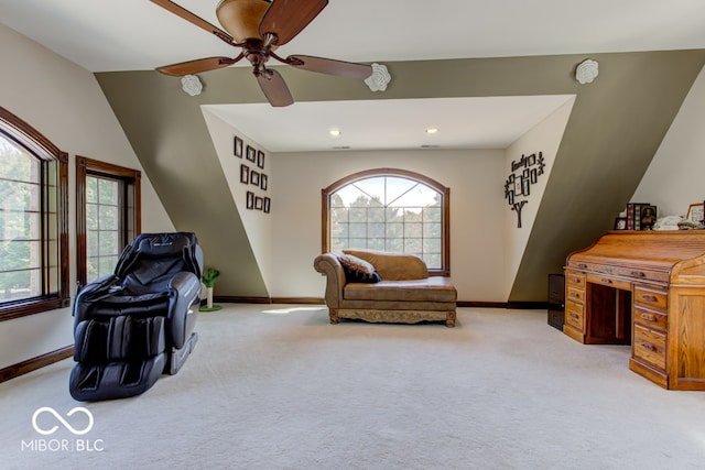 living area with light carpet and ceiling fan