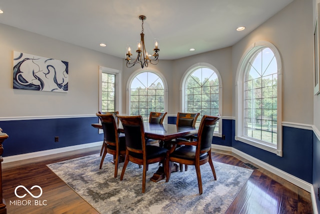 dining space with a chandelier, dark hardwood / wood-style flooring, and plenty of natural light