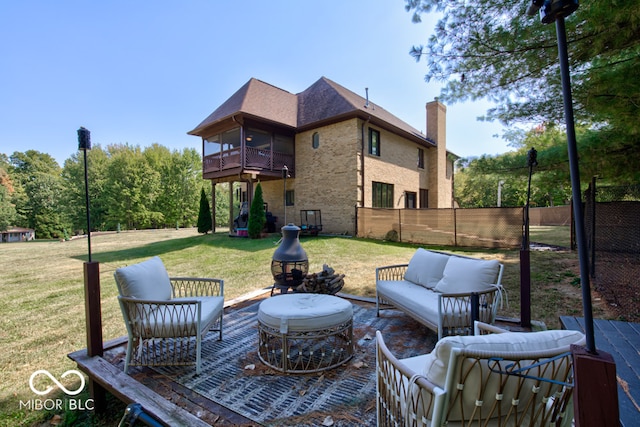 view of patio / terrace with an outdoor living space with a fire pit and a balcony