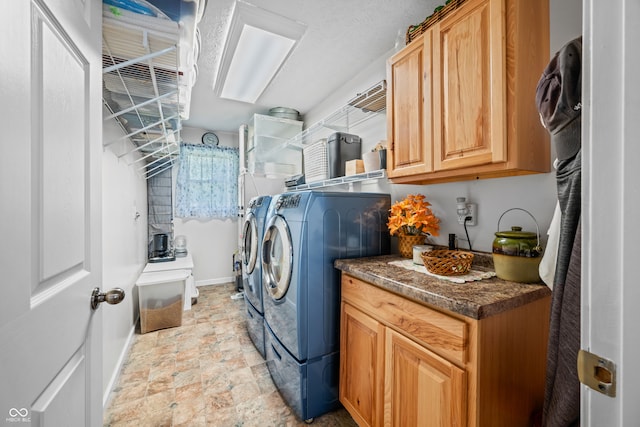 laundry room with separate washer and dryer and cabinets