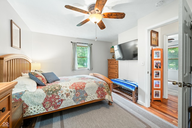 bedroom with wood-type flooring and ceiling fan