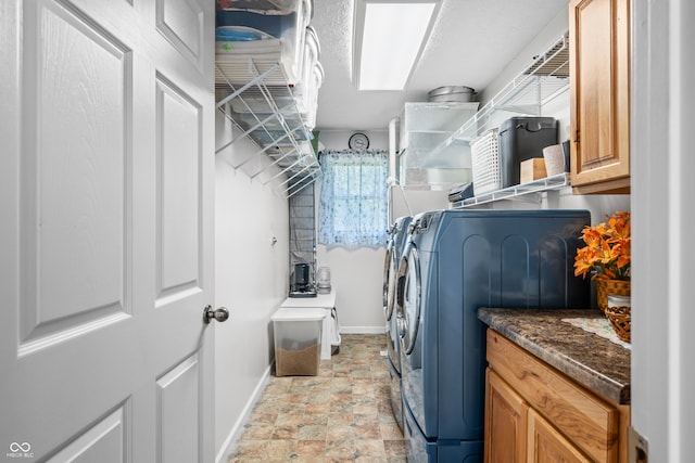 laundry area with cabinets and washer and clothes dryer