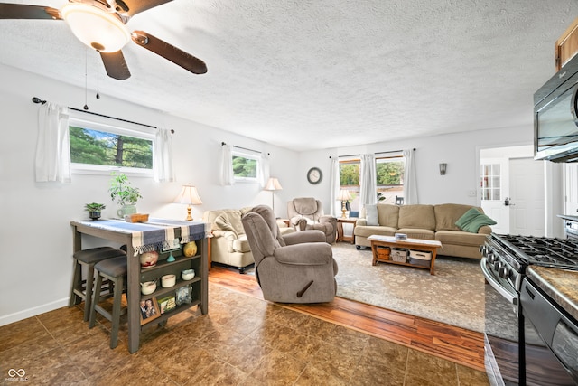 living room featuring a textured ceiling, ceiling fan, and hardwood / wood-style flooring