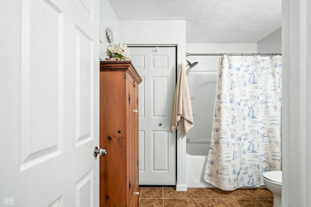 bathroom featuring shower / bath combination with curtain, a textured ceiling, toilet, and tile patterned floors