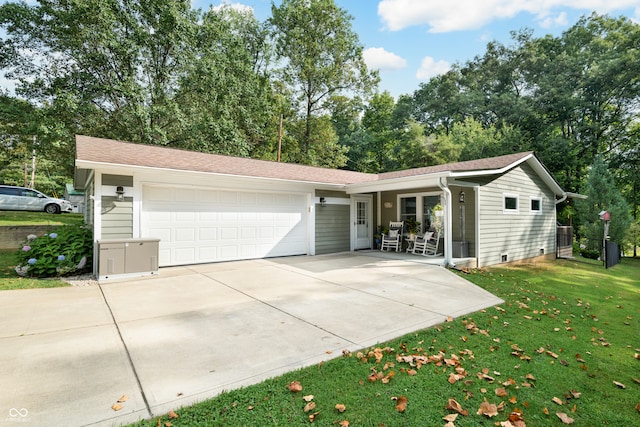 ranch-style home with a garage and a front lawn