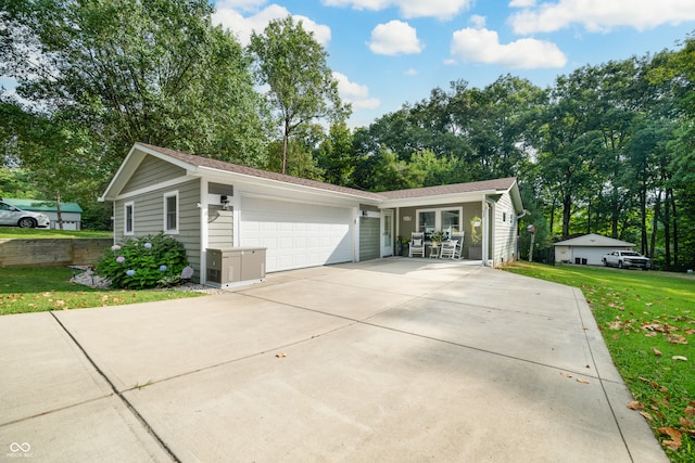 single story home with a garage and a front lawn