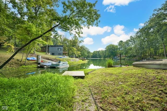 view of yard featuring a boat dock and a water view