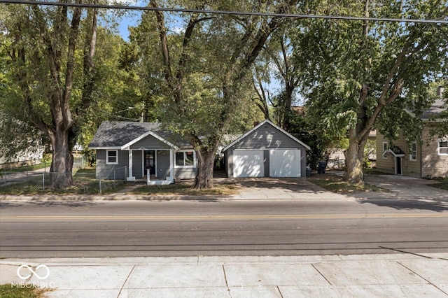 view of front facade with covered porch, an outdoor structure, and a garage