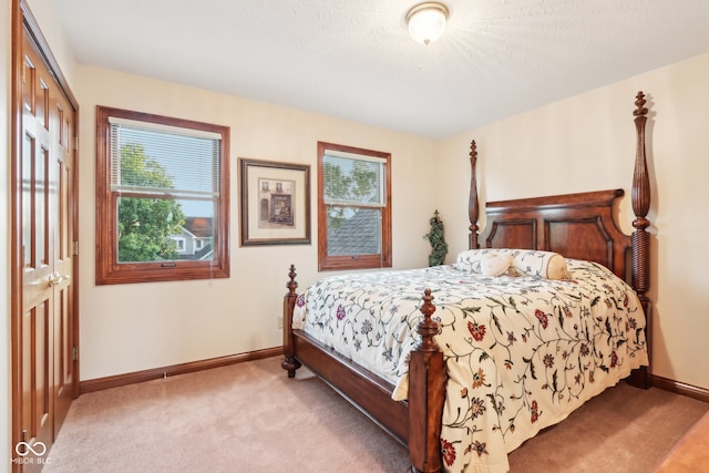 carpeted bedroom featuring a closet