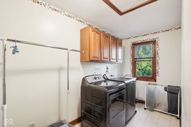 laundry room with washer and clothes dryer and cabinets