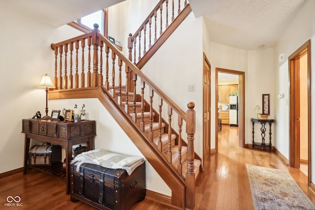 stairs with hardwood / wood-style flooring