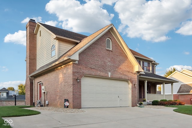 view of side of home featuring a porch and a garage