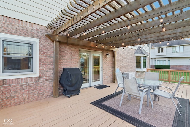 wooden terrace with area for grilling and a pergola