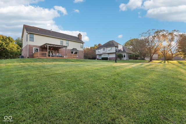 view of yard featuring central AC unit and a deck