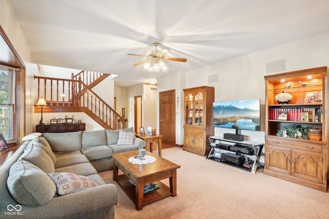 carpeted living room with ceiling fan