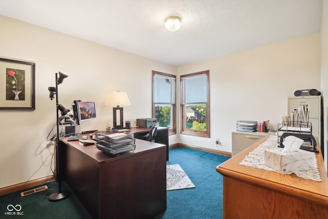 office space with a textured ceiling and dark colored carpet