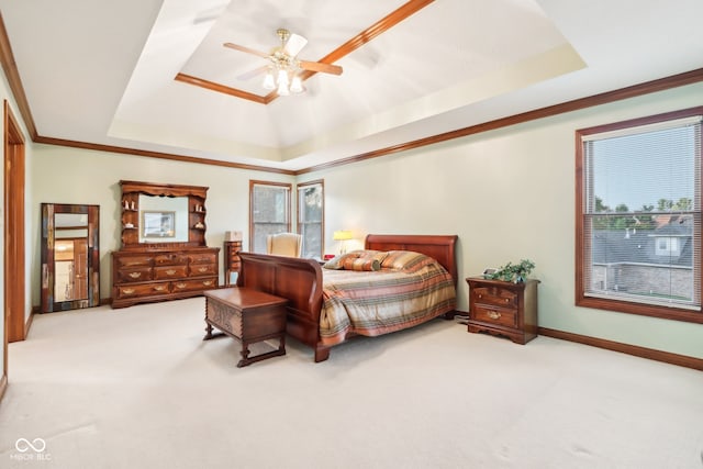 bedroom featuring a raised ceiling, ceiling fan, and light colored carpet