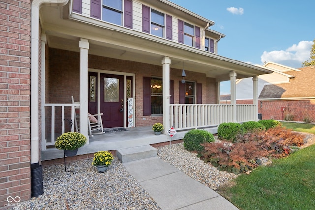 entrance to property featuring a porch