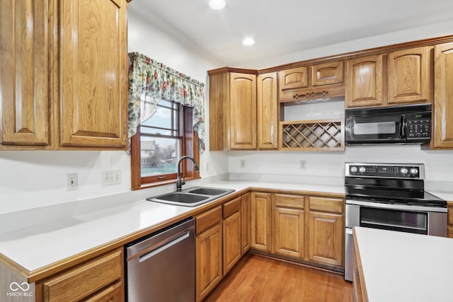 kitchen featuring light hardwood / wood-style floors, sink, and stainless steel appliances