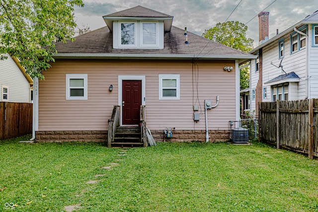 back of house with a lawn and cooling unit