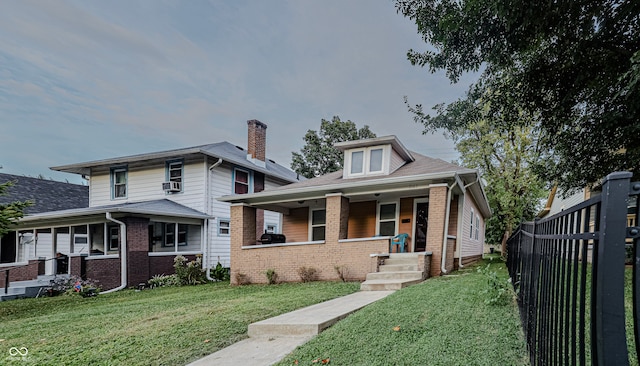 view of front of house featuring a front yard and covered porch