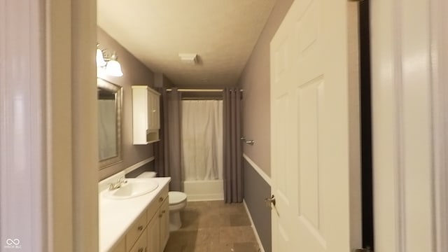 full bathroom featuring shower / bath combo, vanity, and toilet