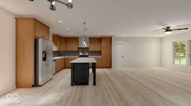 kitchen with ceiling fan, a kitchen island, stainless steel fridge with ice dispenser, white range oven, and light hardwood / wood-style floors