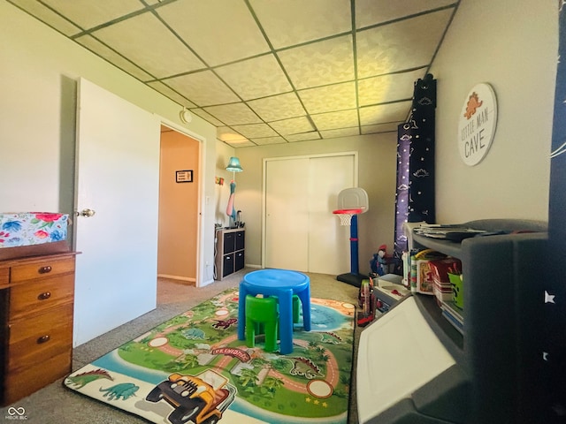 game room featuring a paneled ceiling and carpet flooring