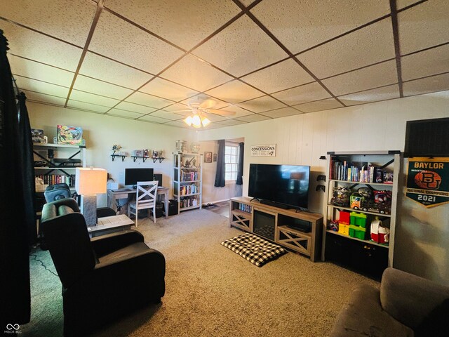 living room with carpet, ceiling fan, and a paneled ceiling