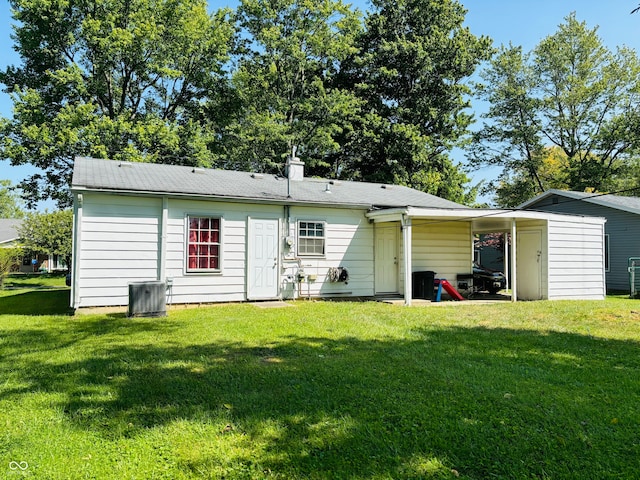 back of property with a lawn and cooling unit